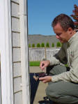 The Exterior Specialists. Inspecting siding and trim details.